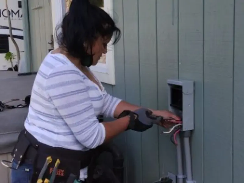 Licensed electrician wiring an exterior subpanel in Storm Lake